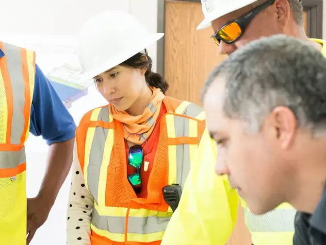 Female Keller project manager talking with colleagues