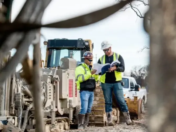 Keller employees looking at plans on site