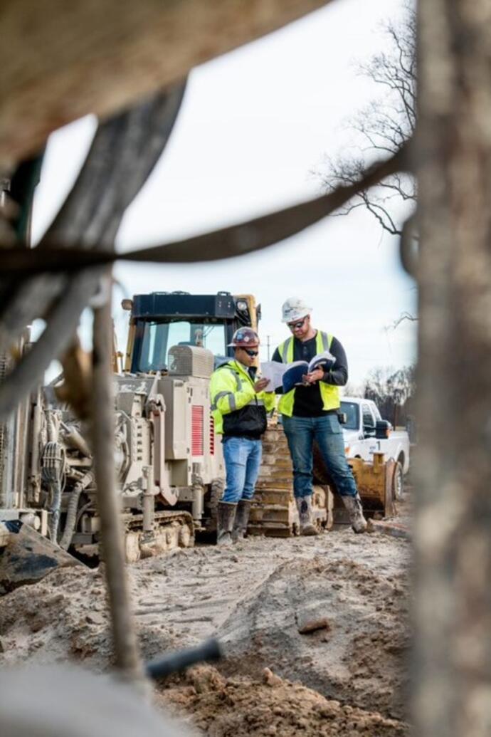 Keller employees looking at plans on site