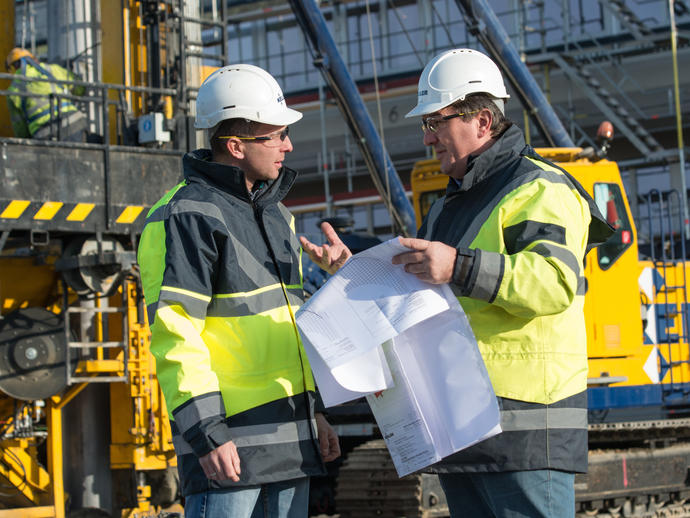 Employees on site discussing project